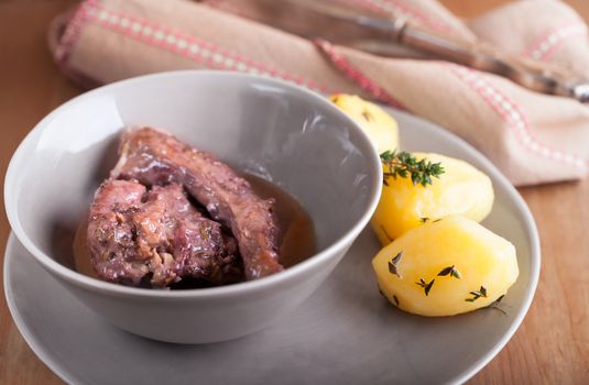 Rabbit meat in winy sauce served on the plate