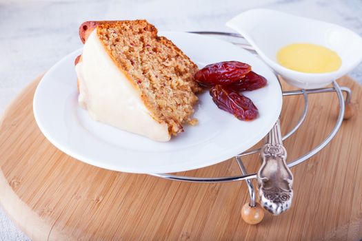 Slice of date cake on a white plate.