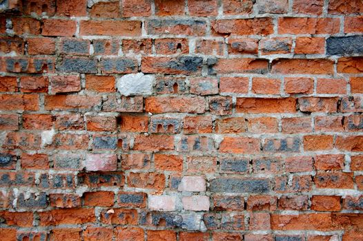 Old and broken red stone brick wall, close up details background