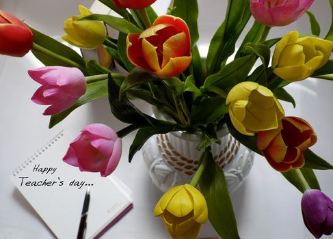 Happy teachers day with handmade tulip flower pot, stack of books, pen, message for teacher in special day of education, tulip bouquet diy from clay material