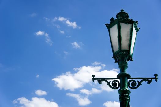 green street lamp post on blue sky background