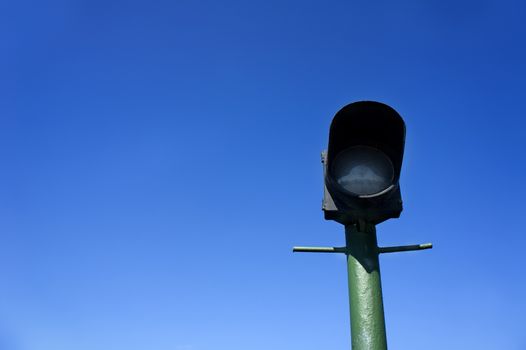 green street lamp post on blue sky background
