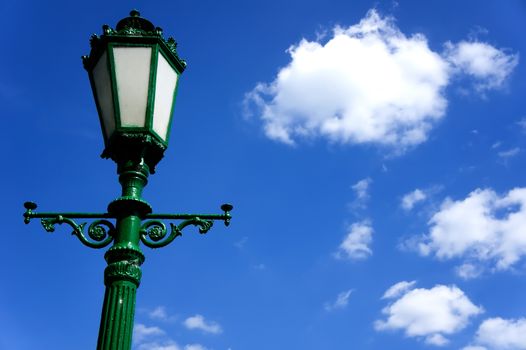 green street lamp post on blue sky background