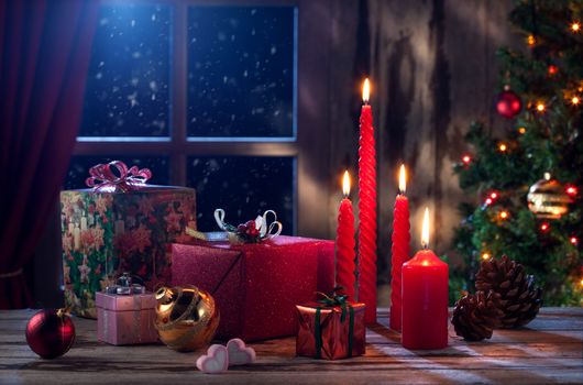 view of gift boxes and red candles on  Christmas background