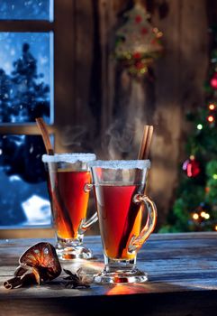 close up view  of  two glasses with mulled wine on color back