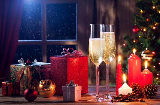 close up view of champagne with candles and gifts on color back
