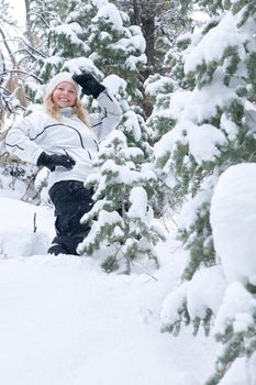 Portrait of young beautiful woman on winter outdoor background.