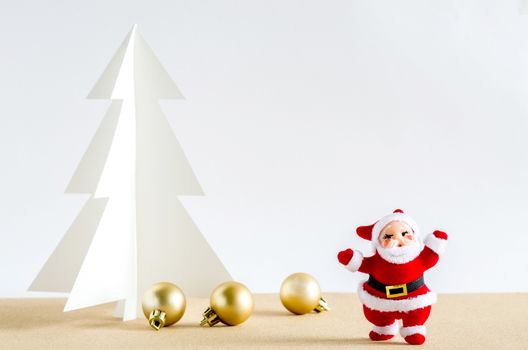 Christmas background. Santa Claus, golden balls and christmas tree paper craft.