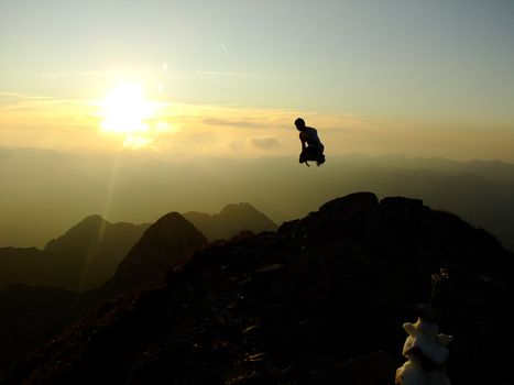 Man jumping up on the Top of the Nebelhorn Mountains in Germany Alps