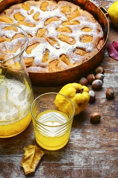 Autumn pie with ripe fruits of quince in a rustic style