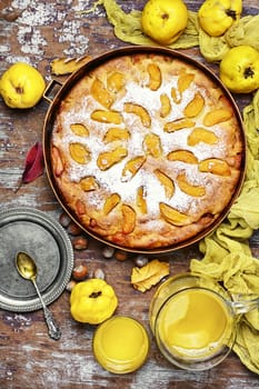 Autumn pie with ripe fruits of quince in a rustic style
