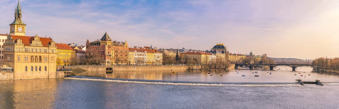 Panorama view with the buildings of Prague, the capital of Czech Republic and the Vltava river, on a sunny day of spring.