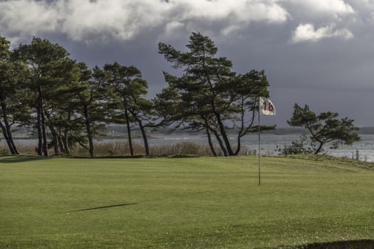18th Whole with Trees and a cloudy sky.