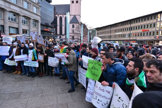 GERMANY, Cologne: Dozens of refugees from Syria, Afghanistan and other  countries demonstrate peacefully against violence and sexism near the Cologne main train station in Cologne, western Germany on January 16, 2016, where hundreds of women were groped and robbed in a throng of mostly Arab and North African men during New Year's festivities. German authorities said that nearly all the suspects in a rash of New Year's Eve violence against women in Cologne were of foreign origin, as foreigners came under attack amid surging tensions. 