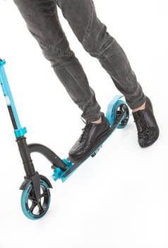 Man's legs on a push-cycle on a studio background