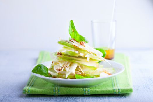Fennel and apple salad on white plate