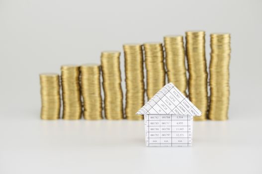 Close up house have blur pile of gold coins on white background.