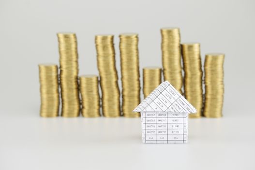 House have blur pile of gold coins on white background.