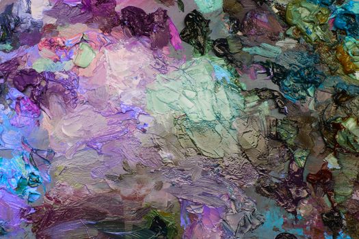 artists oil paints on wooden palette. macro artist's palette, texture mixed oil paints in different colors and saturation. art palette background