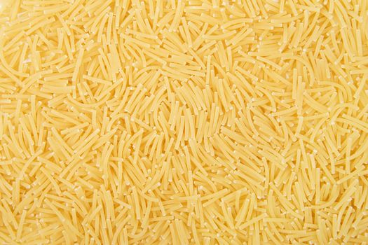 Raw vermicelli pasta background. Close-up of pastas (macaroni)