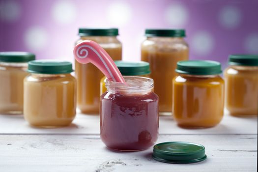 healthy ready-made baby food on a wooden table.