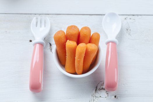 healthy ready-made baby food on a wooden table.