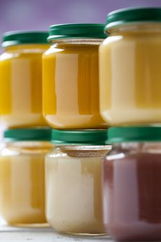 healthy ready-made baby food on a wooden table.