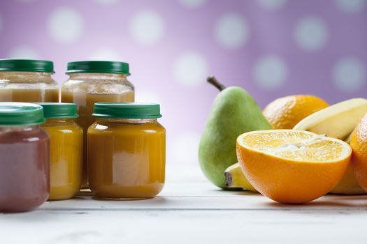 healthy ready-made baby food on a wooden table.