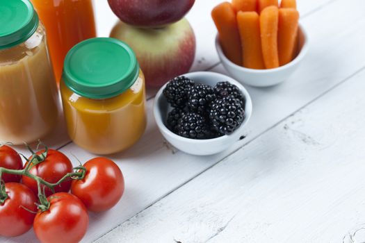 healthy ready-made baby food on a wooden table.