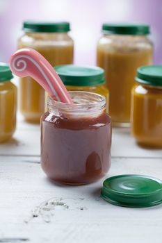 healthy ready-made baby food on a wooden table.