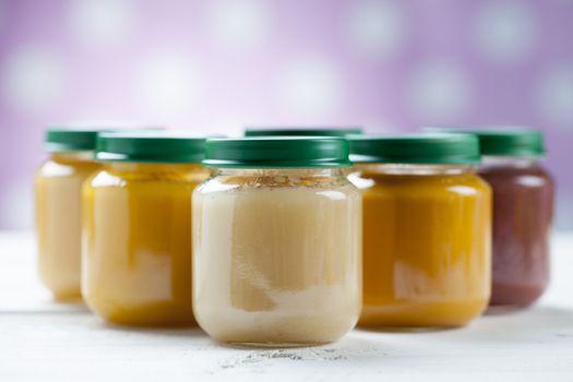 healthy ready-made baby food on a wooden table.