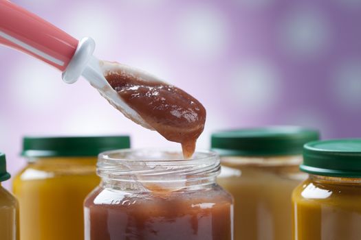 healthy ready-made baby food on a wooden table.