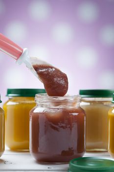 healthy ready-made baby food on a wooden table.