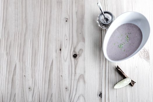 Chestnut soup with milk and cinnamon on white board