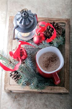 Christmas cocoa in mug on the wooden tray.