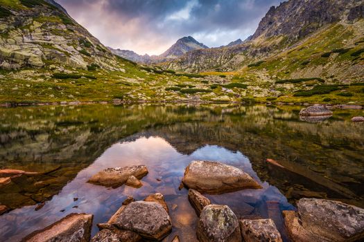 Mountain Lake Above Skok Waterfall with Rocks in Foreground and Strbsky Peak in Background at Sunset. Mlynicka Valley, High Tatra, Slovakia.