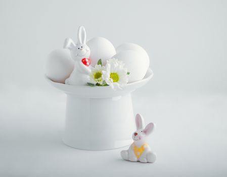 Easter symbols - Eggs and Bunny on a white table