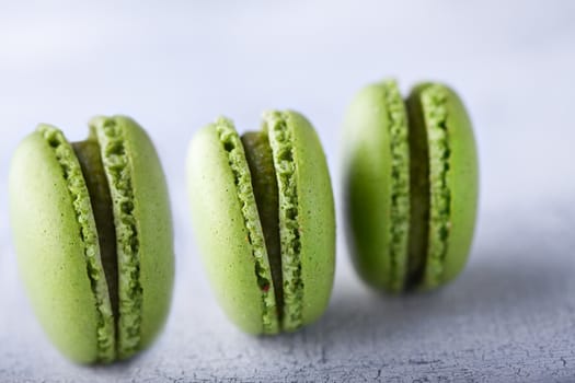 Three green french pistachios Macaroons on a table