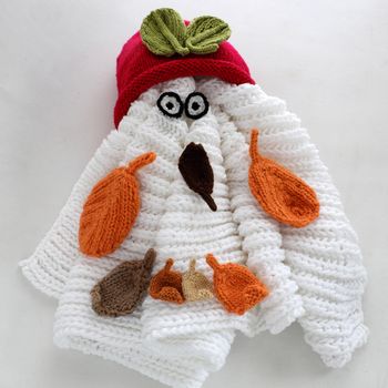 Diy funny, humor Christmas background handmade with lazy snowman from white scarf, red hat, eye and group of knitted leaf from yarn, winter leaves drop on head in cold day, art design for Xmas holiday