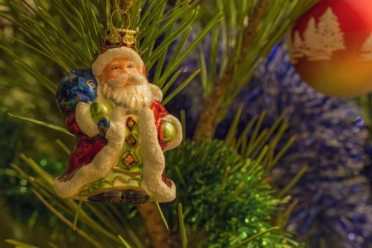 beautiful small santa clause and garland on christmas tree .Close