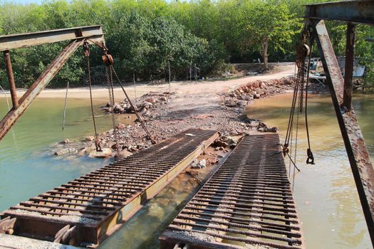 steel bridge of container ship connect on island ground for construction