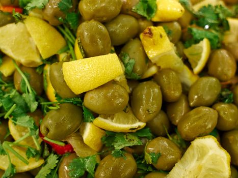 Traditional pickled Mediterranean style green olives for sale in a market shop