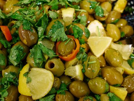 Traditional pickled Mediterranean style green olives for sale in a market shop