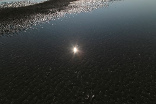 sun reflect in water of Beach in Sea when water down