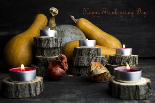 Happy Thanksgiving Day, Decoration on a wooden table with Burning Candles and  Pumpkins, Corncob, autumn leaves in the background