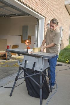 Carpenter repairing exterior door casing, weather & insects have contributed to rot at the bottom of casing,   