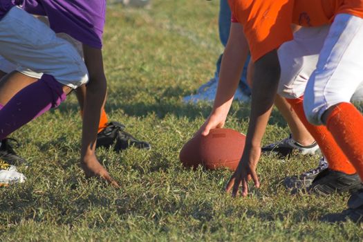 Children playing peewee football at local park