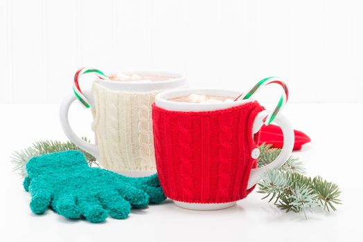 Two mugs of hot chocolate flavored with candy canes.