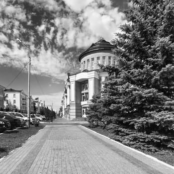 The city of Saransk in the summer. Republic Of Mordovia, Russia. People at a distance. Black-and-white image.