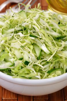 Salad of fresh coleslaw with cucumber and dill